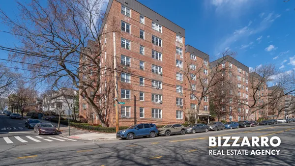 a street view with tall buildings and a street sign