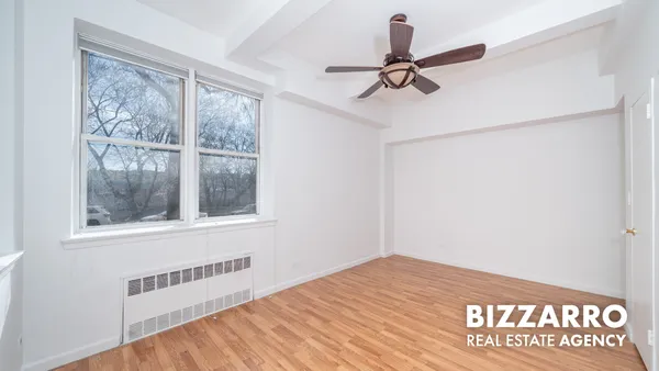 a view of a room with a window and ceiling fan