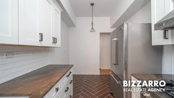 a bedroom with a bed and a sink