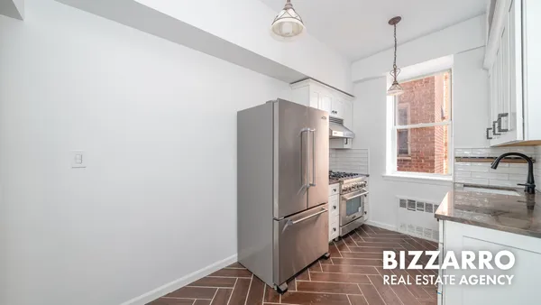 a kitchen with stainless steel appliances granite countertop a refrigerator and a sink