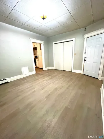 an empty room with windows and closet