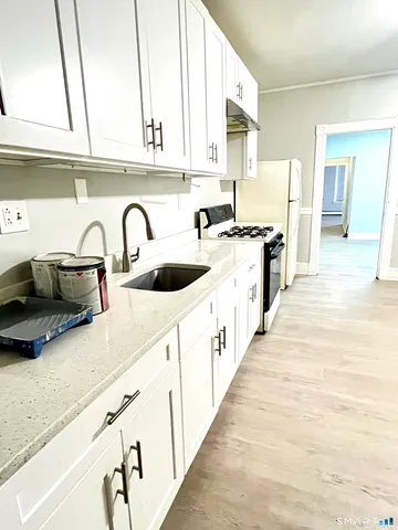 a kitchen with stainless steel appliances a sink and cabinets