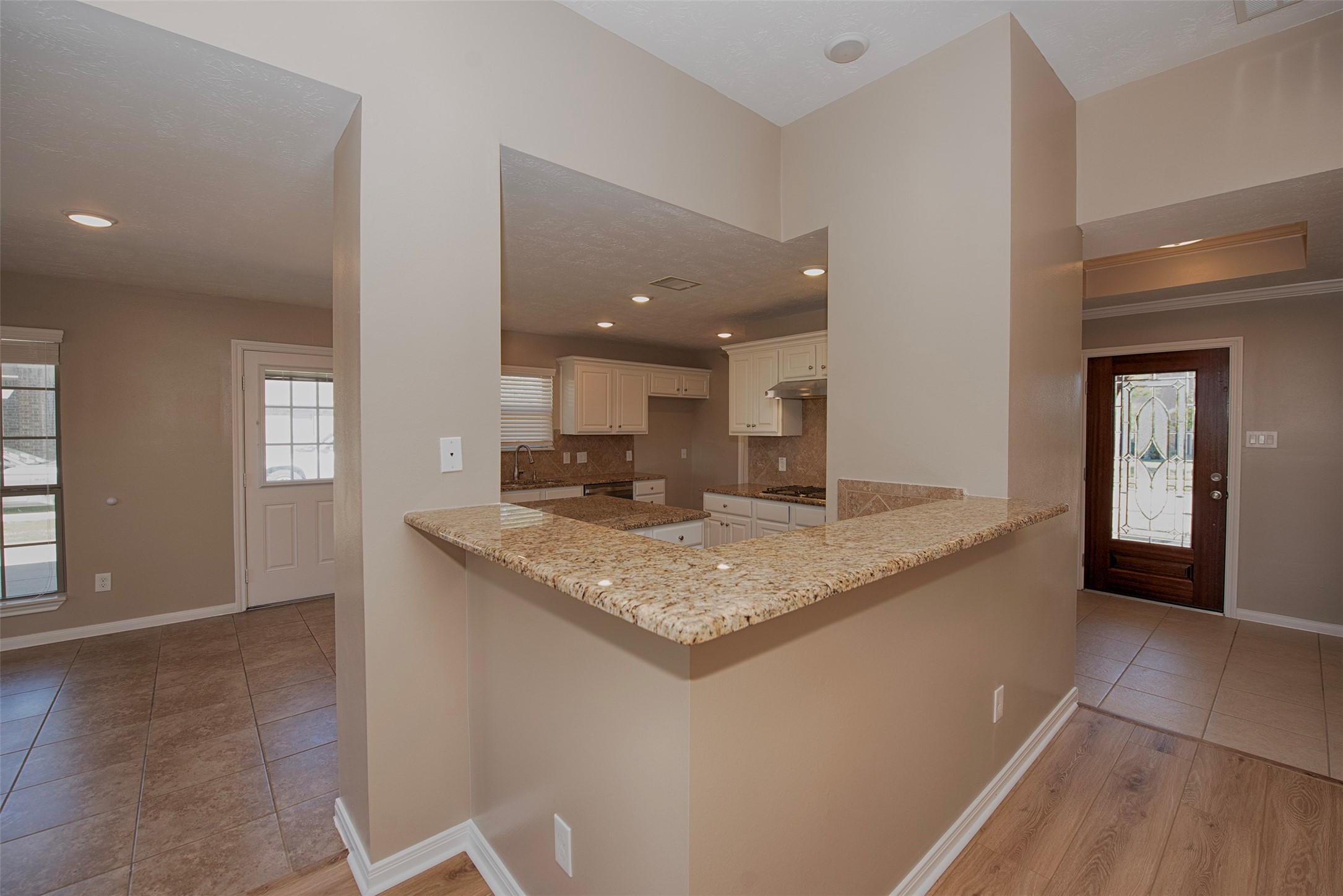 6714 Lone Star Ridge Manvel, TX 77578 - Photo 11 of 37 a kitchen with a granite countertop sink and a granite counter top