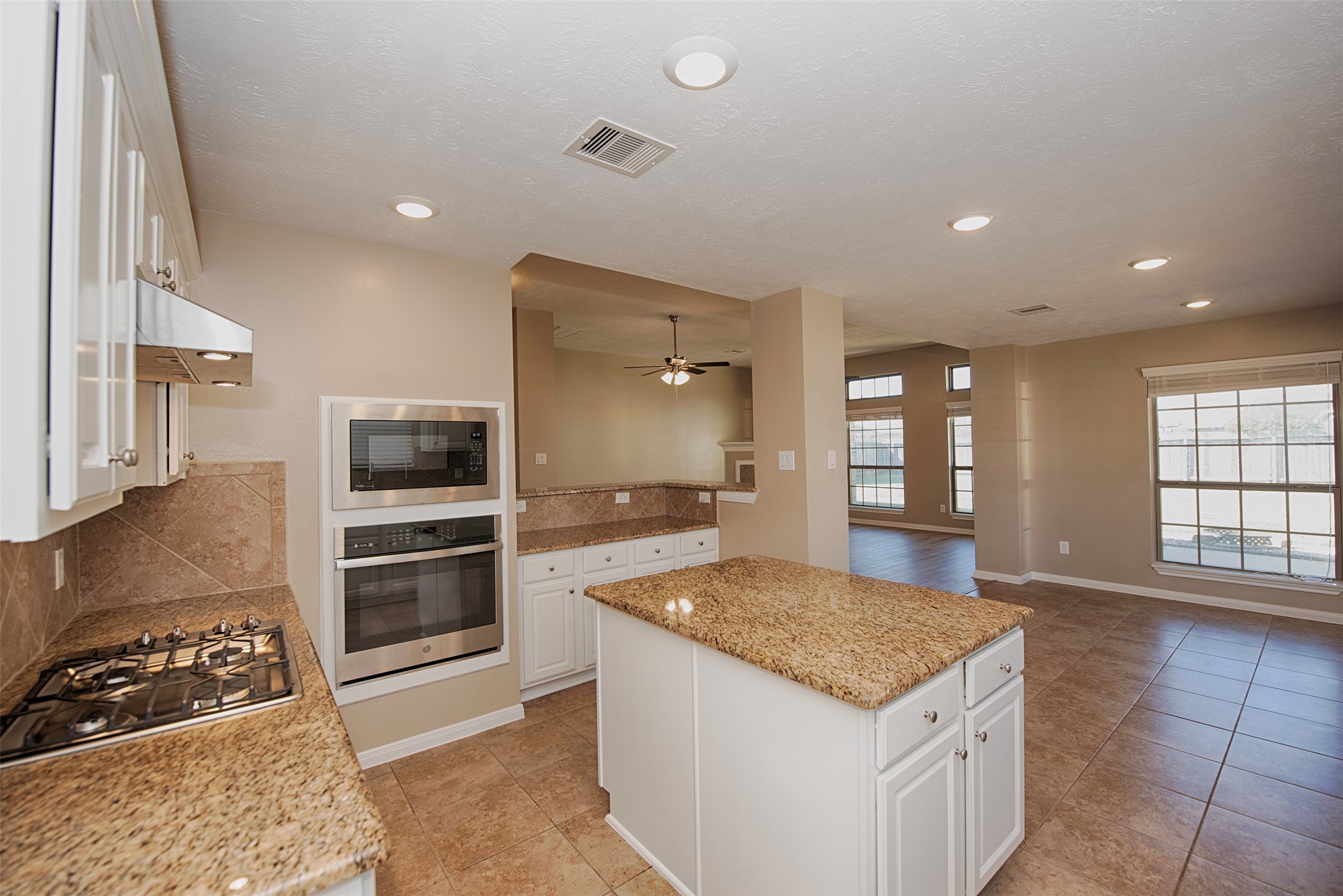 6714 Lone Star Ridge Manvel, TX 77578 - Photo 12 of 37 a kitchen with a stove a sink and a refrigerator