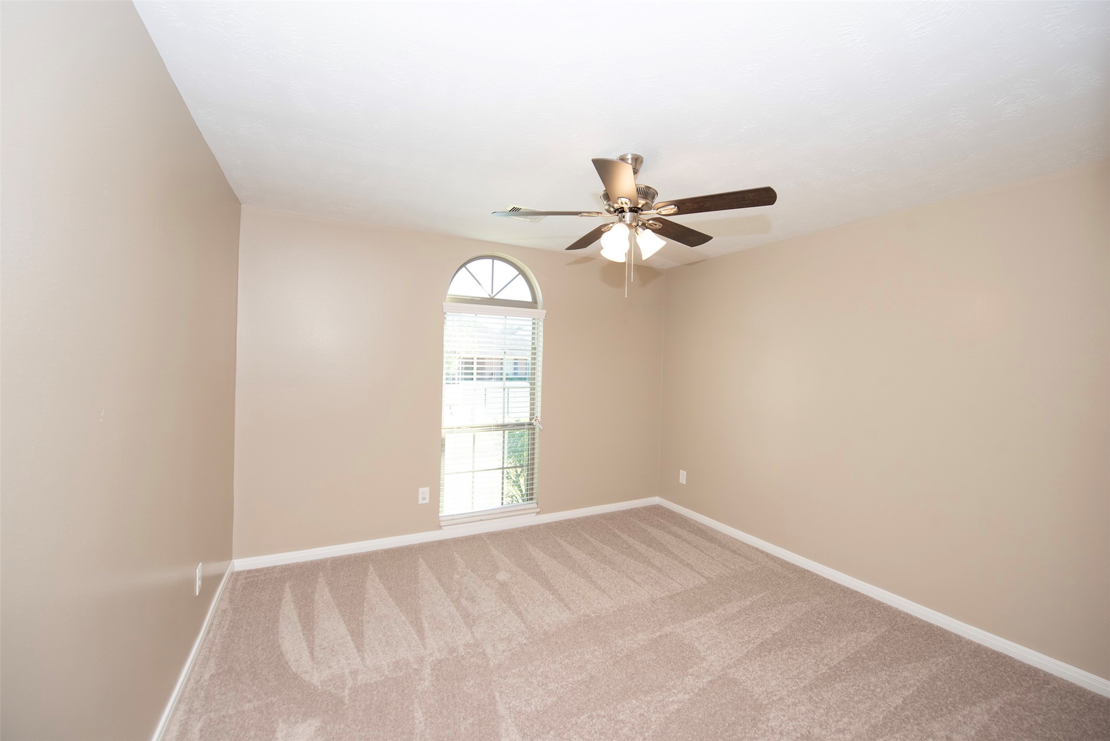 6714 Lone Star Ridge Manvel, TX 77578 - Photo 26 of 37 an empty room with a window and a fan