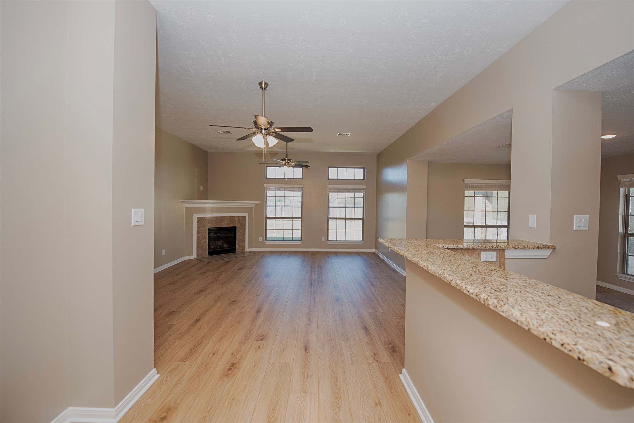 6714 Lone Star Ridge Manvel, TX 77578 - Photo 6 of 37 an empty room with wooden floor and fireplace