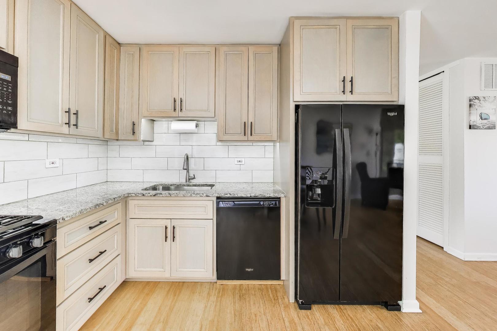 420 Bode Road Hoffman Estates, IL 60169 - Photo 8 of 20 a kitchen with a refrigerator and cabinets