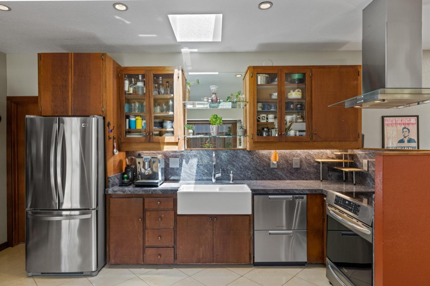 a kitchen with stainless steel appliances a sink stove and refrigerator