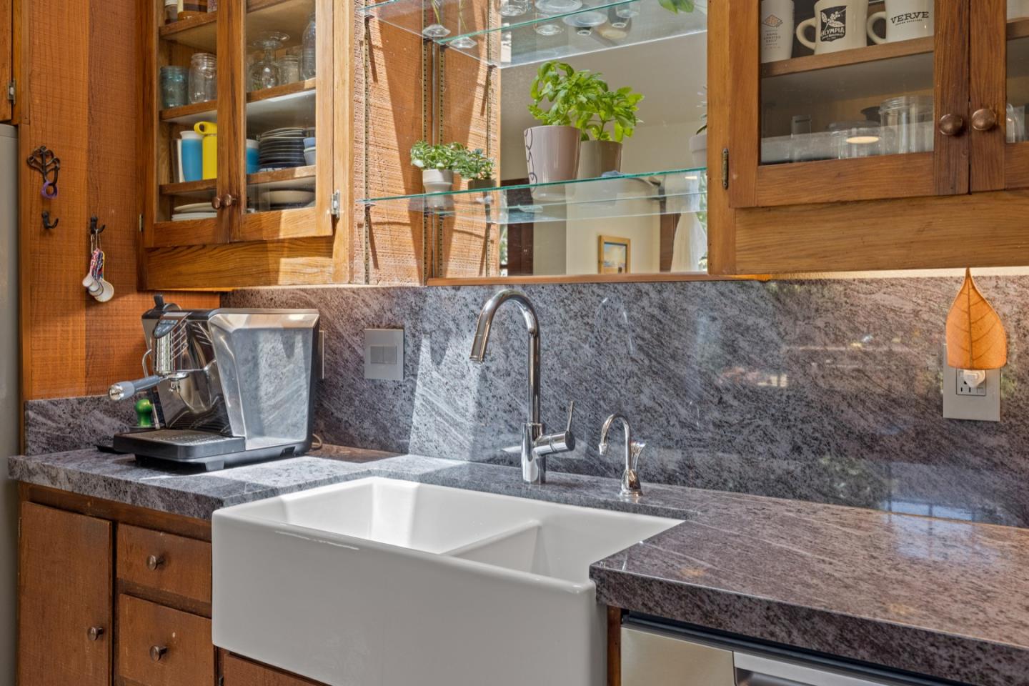 314 3rd Street Pacific Grove, CA 93950 - Photo 13 of 35 a bathroom with a granite countertop sink and a mirror