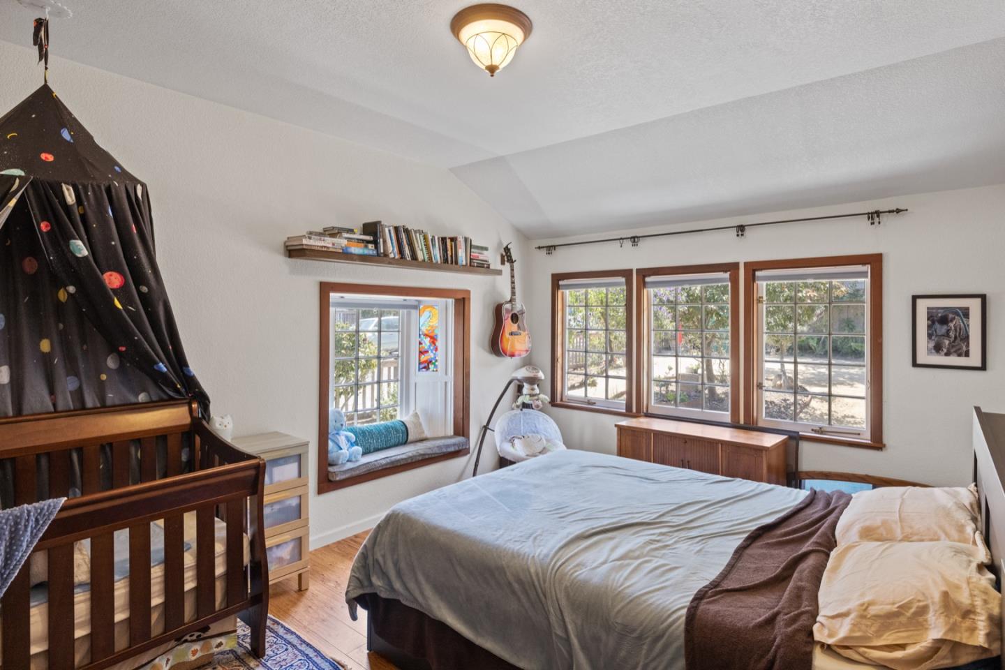 314 3rd Street Pacific Grove, CA 93950 - Photo 16 of 35 a bedroom with a bed and a large window with outer view