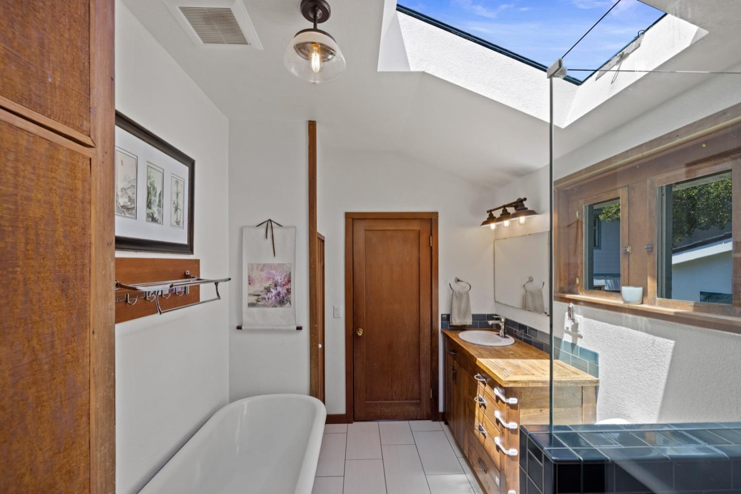 314 3rd Street Pacific Grove, CA 93950 - Photo 20 of 35 a bathroom with a sink a mirror and a shower