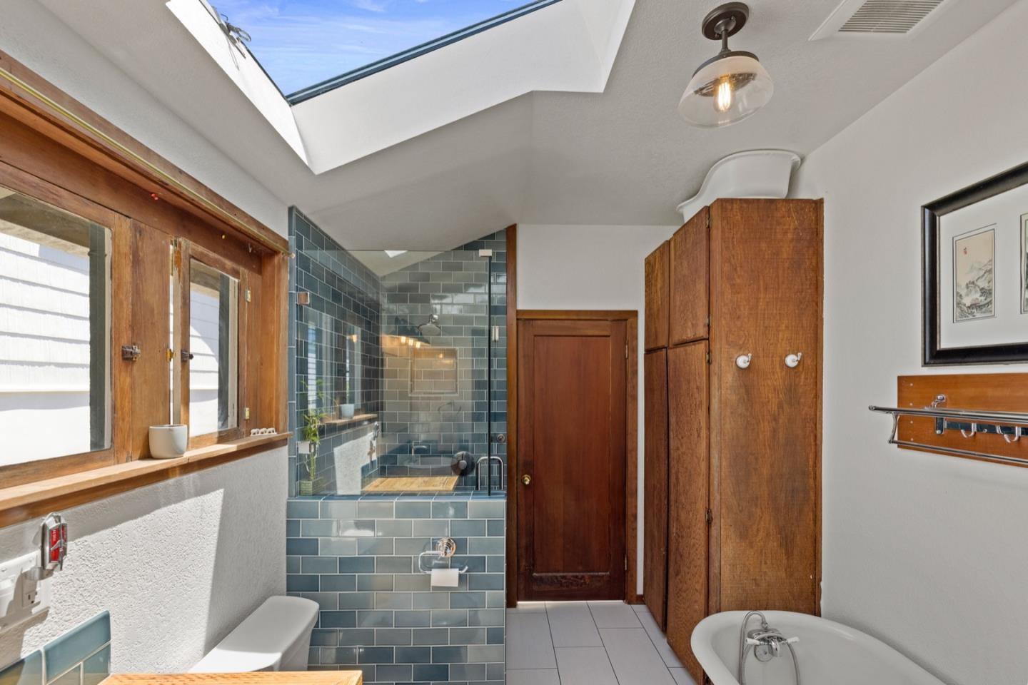 314 3rd Street Pacific Grove, CA 93950 - Photo 21 of 35 a bathroom with a granite countertop sink mirror vanity and toilet