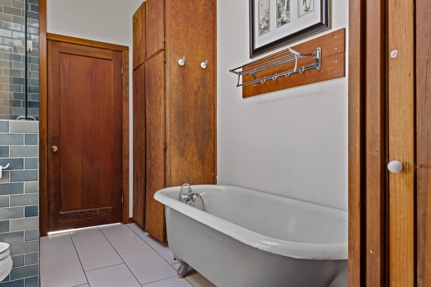 314 3rd Street Pacific Grove, CA 93950 - Photo 22 of 35 a bathroom with a bathtub and shower