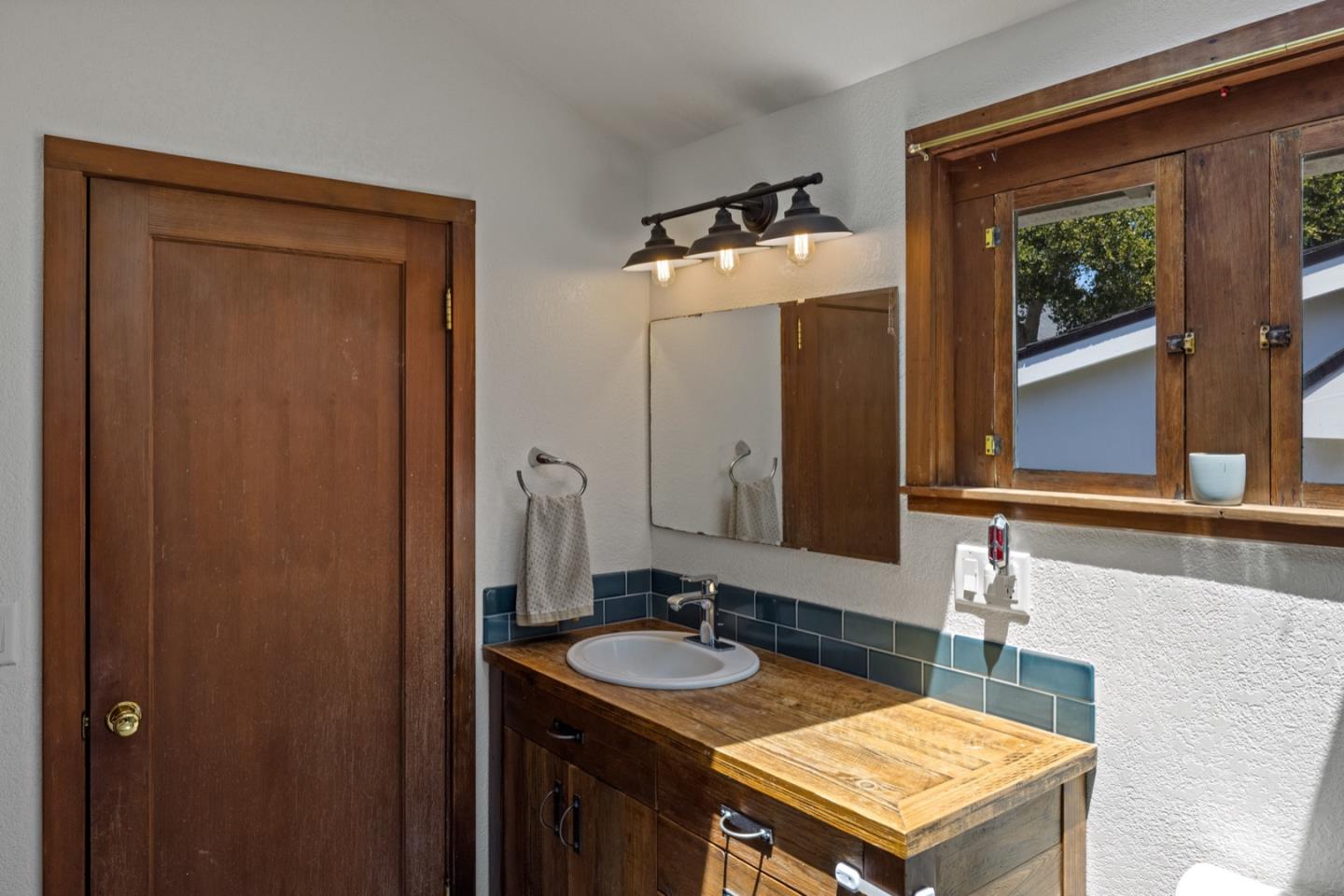 314 3rd Street Pacific Grove, CA 93950 - Photo 24 of 35 a bathroom with a sink and a mirror