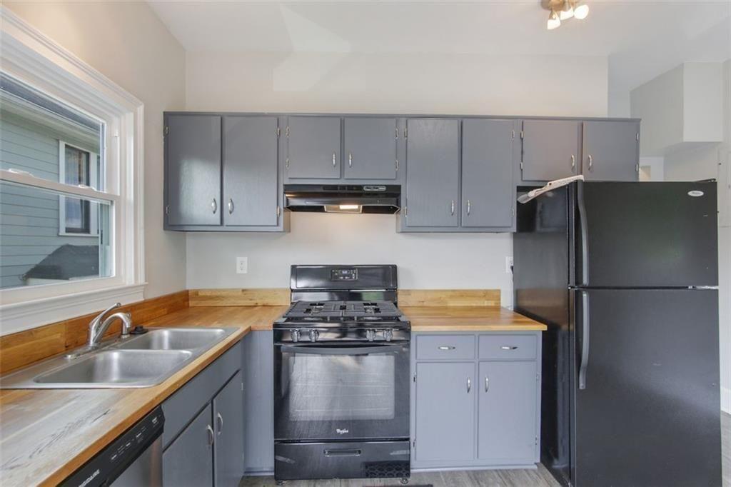 693 Myrtle Street Northeast Atlanta, GA 30308 - Photo 18 of 35 a kitchen with a refrigerator stove and sink