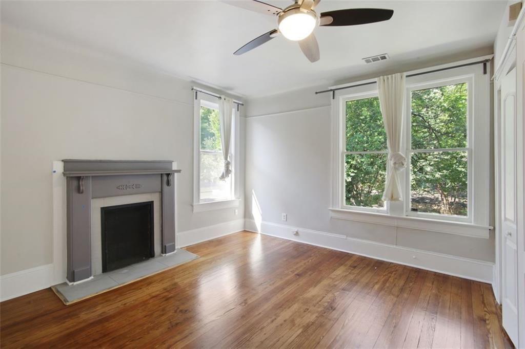 693 Myrtle Street Northeast Atlanta, GA 30308 - Photo 21 of 35 a view of an empty room with wooden floor and a window