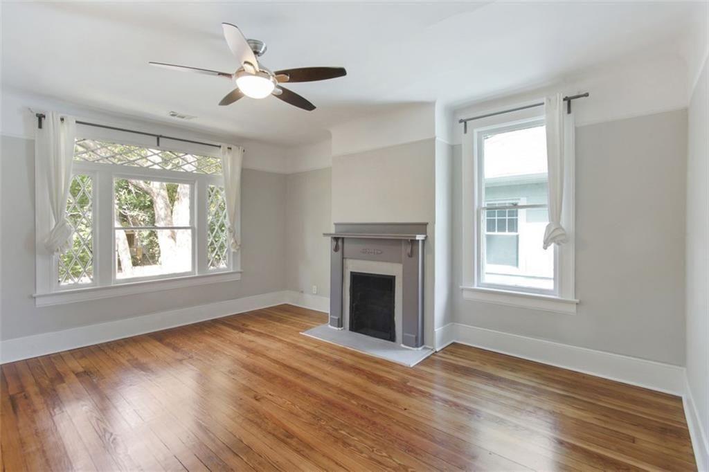 693 Myrtle Street Northeast Atlanta, GA 30308 - Photo 23 of 35 a view of an empty room with wooden floor and a window