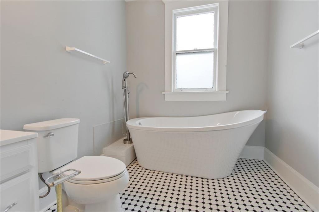 693 Myrtle Street Northeast Atlanta, GA 30308 - Photo 24 of 35 a white bath tub sitting next to a toilet