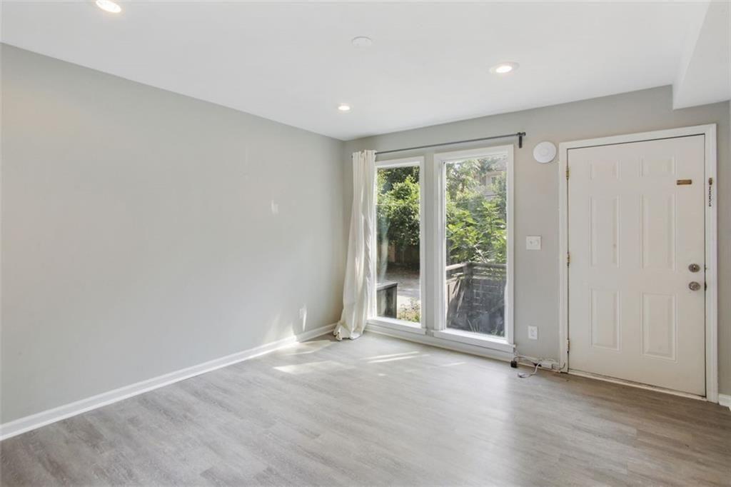 693 Myrtle Street Northeast Atlanta, GA 30308 - Photo 25 of 35 a view of an empty room with wooden floor and a window