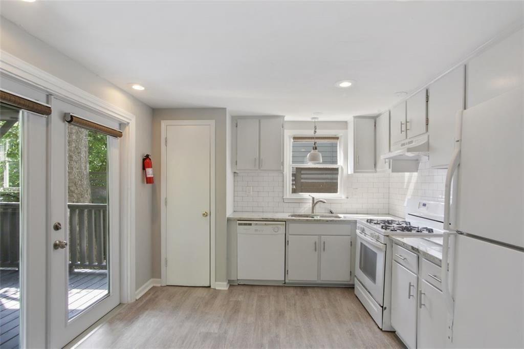 693 Myrtle Street Northeast Atlanta, GA 30308 - Photo 26 of 35 a view of a kitchen with stainless steel appliances granite countertop a refrigerator and a sink