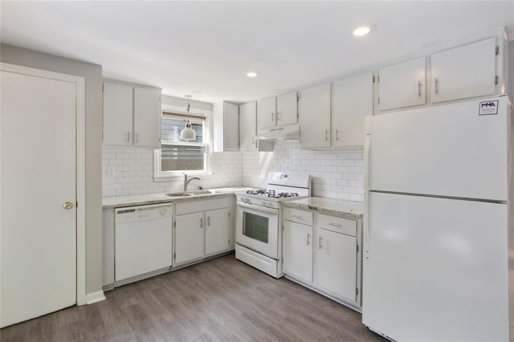 693 Myrtle Street Northeast Atlanta, GA 30308 - Photo 27 of 35 a kitchen with white cabinets and white appliances