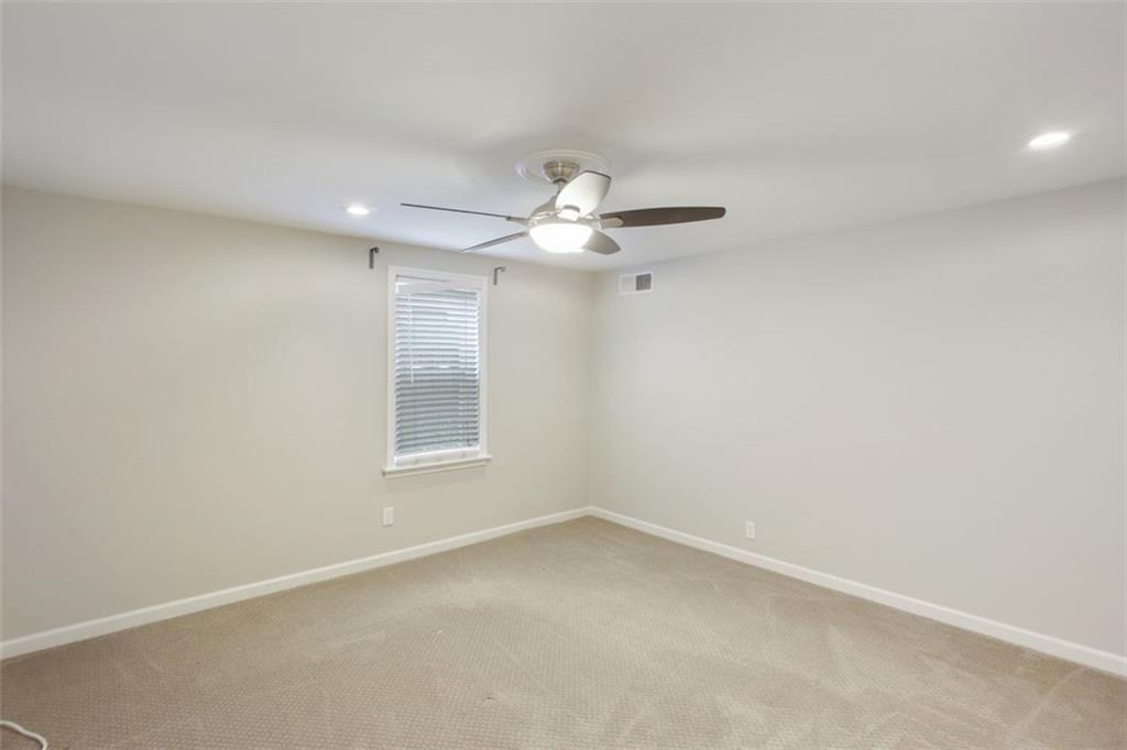 693 Myrtle Street Northeast Atlanta, GA 30308 - Photo 28 of 35 an empty room with a window and a fan