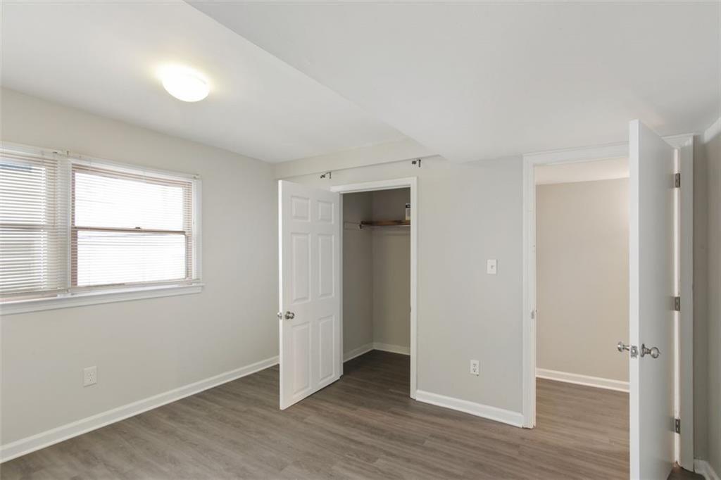 693 Myrtle Street Northeast Atlanta, GA 30308 - Photo 29 of 35 an empty room with wooden floor and windows