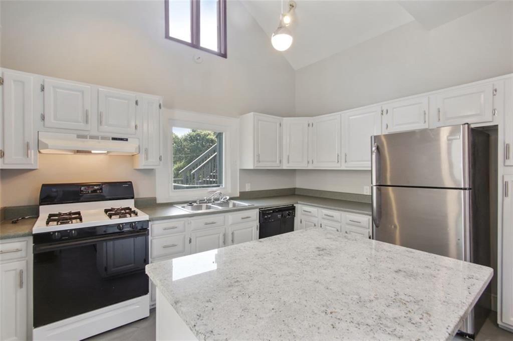 693 Myrtle Street Northeast Atlanta, GA 30308 - Photo 10 of 35 a kitchen with a stove a refrigerator and a sink