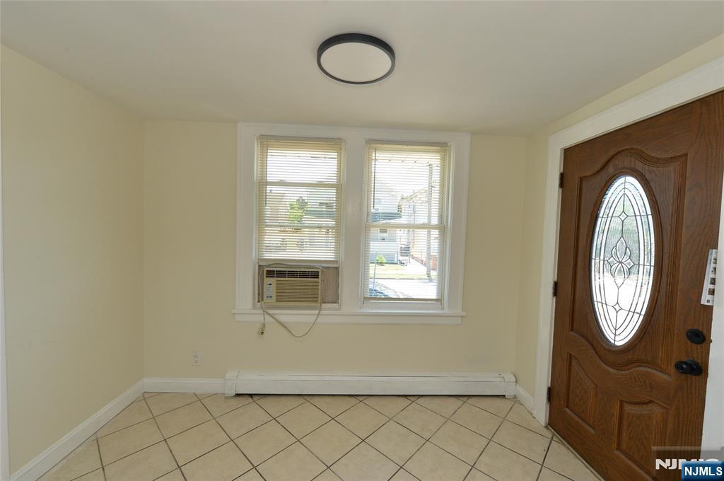 62 Broadway, Unit 1 Hackensack, NJ 07601 - Photo 3 of 25 an empty room with mirror and windows