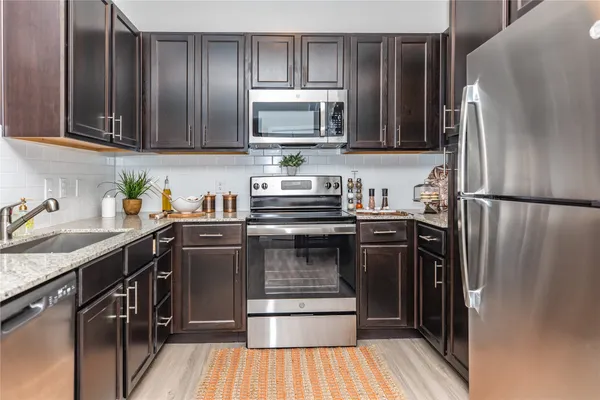 a kitchen with a sink stainless steel appliances and cabinets