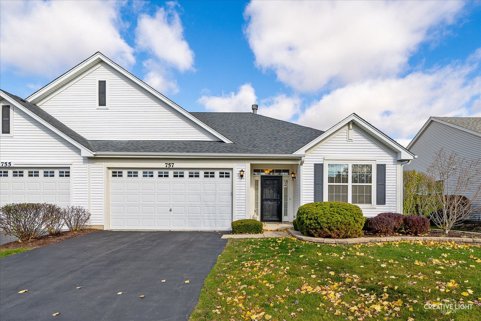 a view of a house with a yard and garage