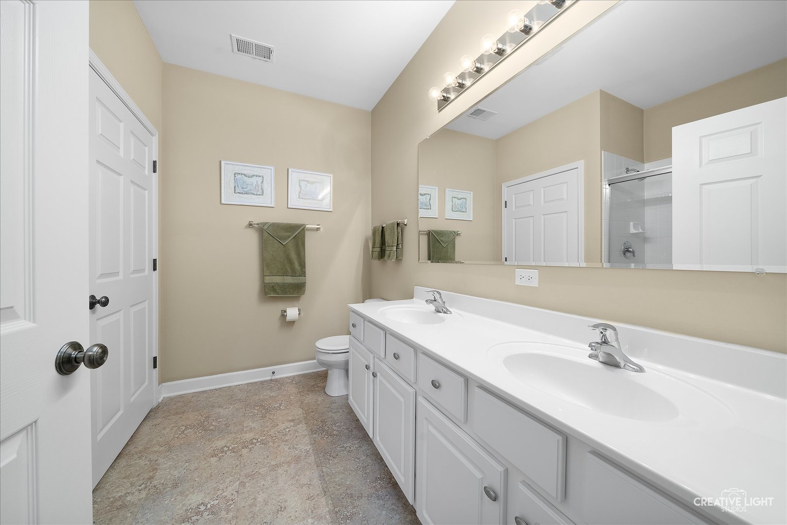 757 Bellevue Circle Oswego, IL 60543 - Photo 14 of 19 a spacious bathroom with a double vanity sink a mirror and a bathtub