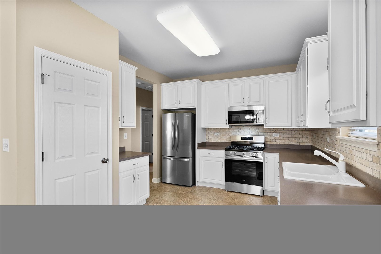 757 Bellevue Circle Oswego, IL 60543 - Photo 10 of 19 a kitchen with stainless steel appliances granite countertop a refrigerator a stove and a sink