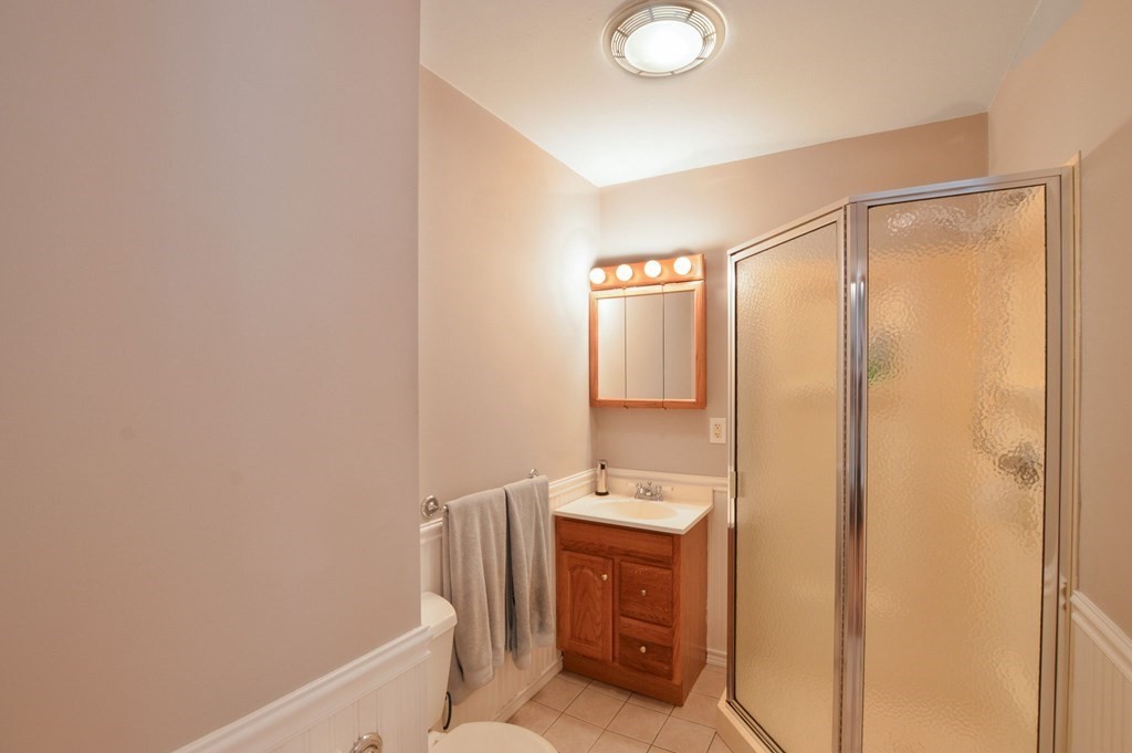 56 Curtis Road Revere, MA 02151 - Photo 11 of 22 a bathroom with a shower a sink and a mirror