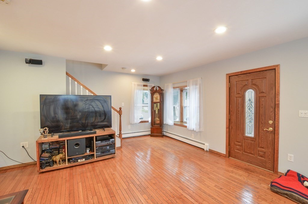 56 Curtis Road Revere, MA 02151 - Photo 12 of 22 a living room with furniture and a flat screen tv