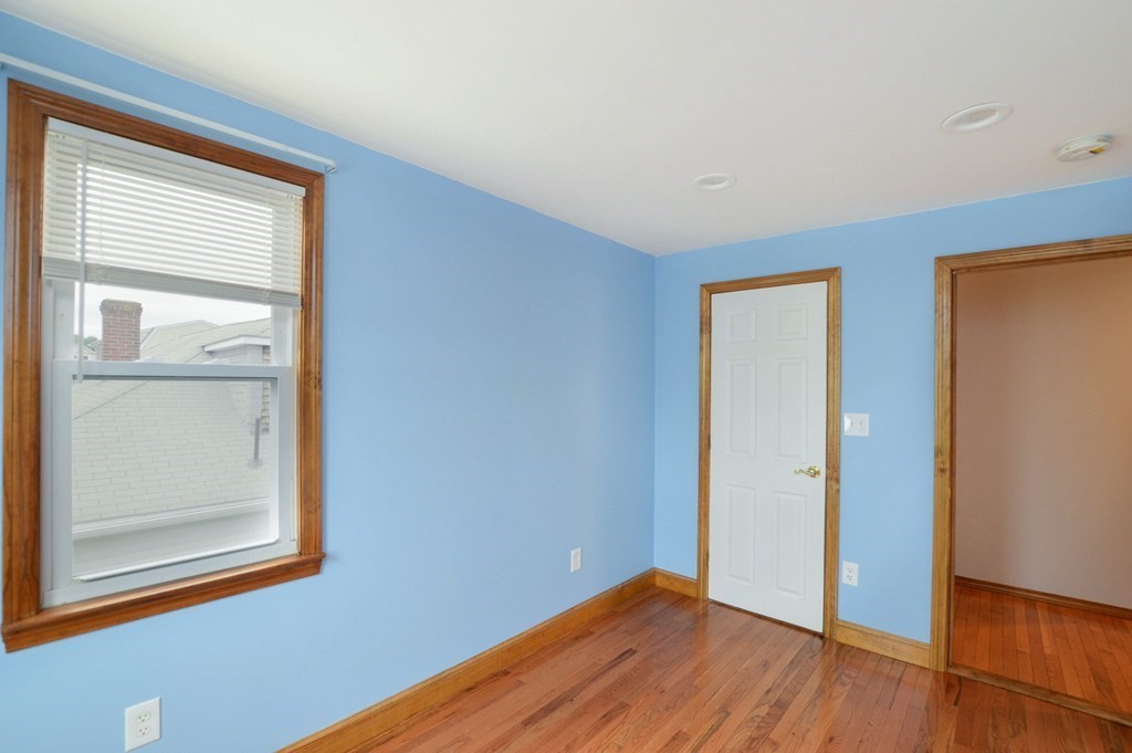 56 Curtis Road Revere, MA 02151 - Photo 15 of 22 a view of empty room with wooden floor and fan