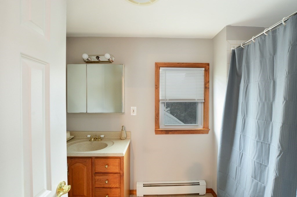 56 Curtis Road Revere, MA 02151 - Photo 16 of 22 a bathroom with a sink and a mirror