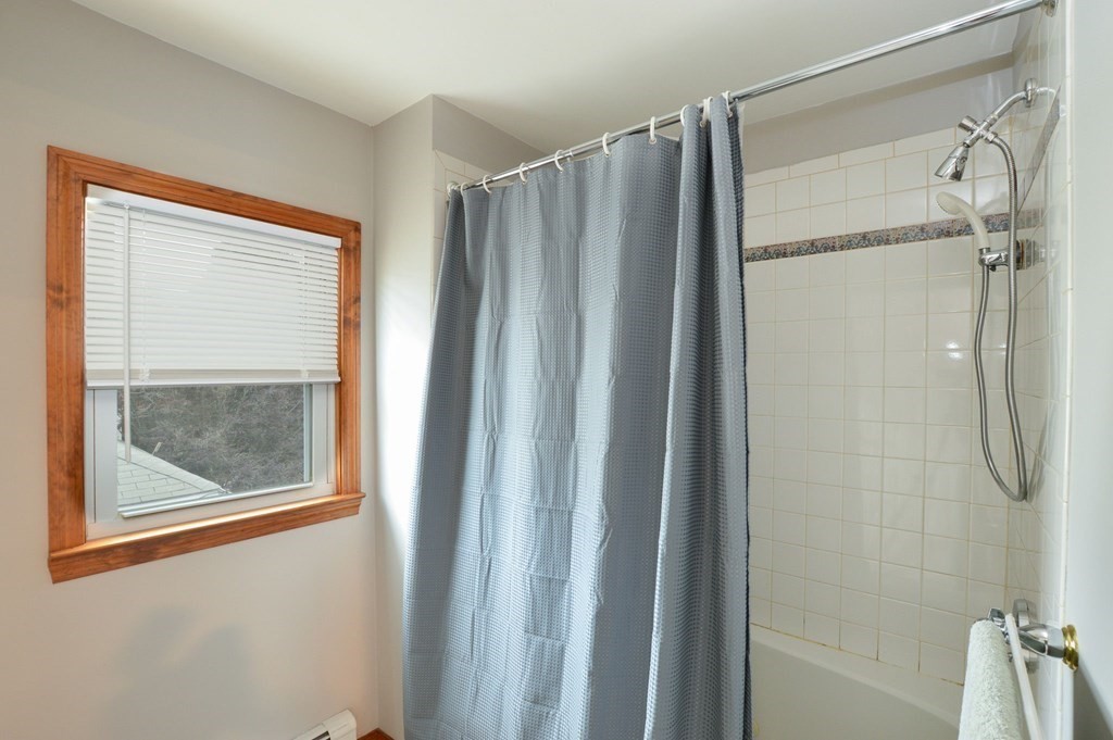 56 Curtis Road Revere, MA 02151 - Photo 17 of 22 a bathroom with a shower and a mirror