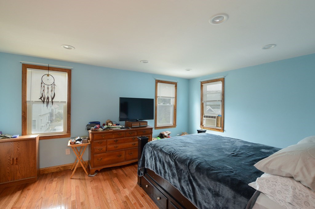 56 Curtis Road Revere, MA 02151 - Photo 18 of 22 a bedroom with a bed and a flat screen tv