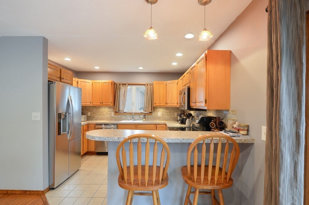 56 Curtis Road Revere, MA 02151 - Photo 6 of 22 a kitchen with stainless steel appliances kitchen island granite countertop a sink and cabinets