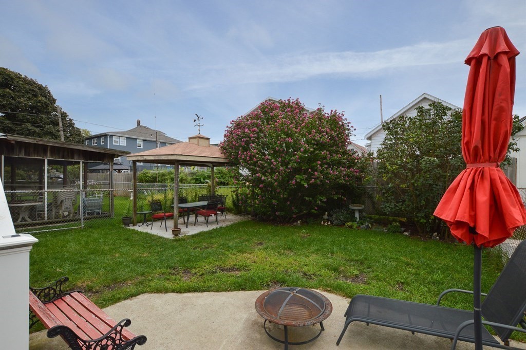 56 Curtis Road Revere, MA 02151 - Photo 8 of 22 a view of a backyard with table and chairs and potted plants