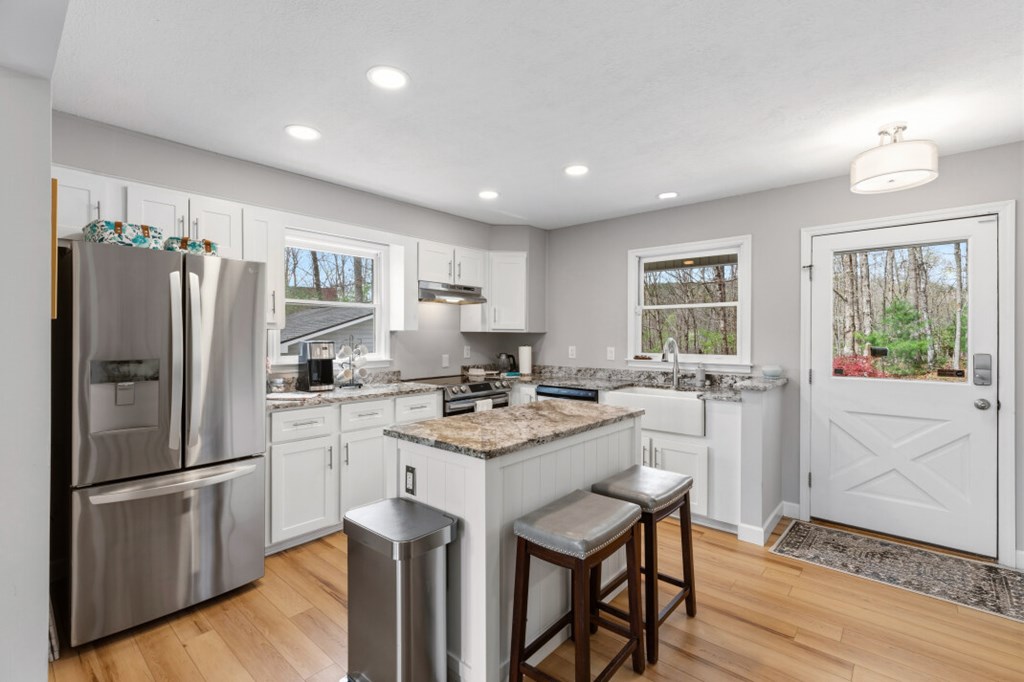 1682 Settlement Road Young Harris, GA 30582 - Photo 11 of 72 a kitchen with white cabinets and stainless steel appliances