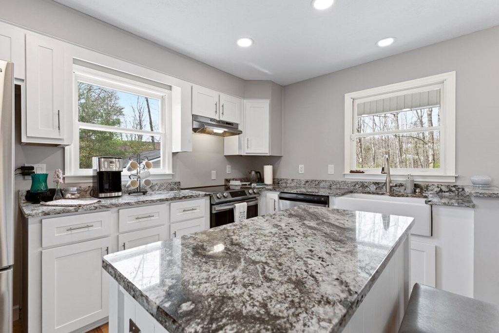 1682 Settlement Road Young Harris, GA 30582 - Photo 12 of 72 a kitchen with stainless steel appliances granite countertop sink stove top oven and cabinets