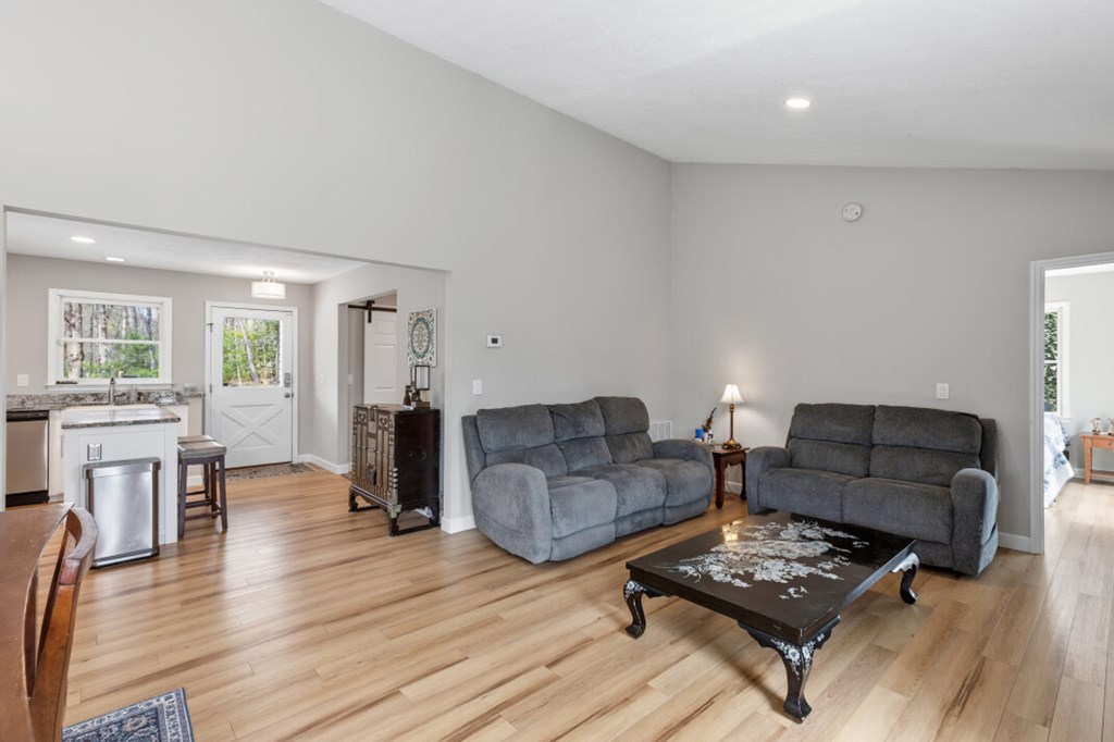 1682 Settlement Road Young Harris, GA 30582 - Photo 16 of 72 a living room with furniture and a wooden floor