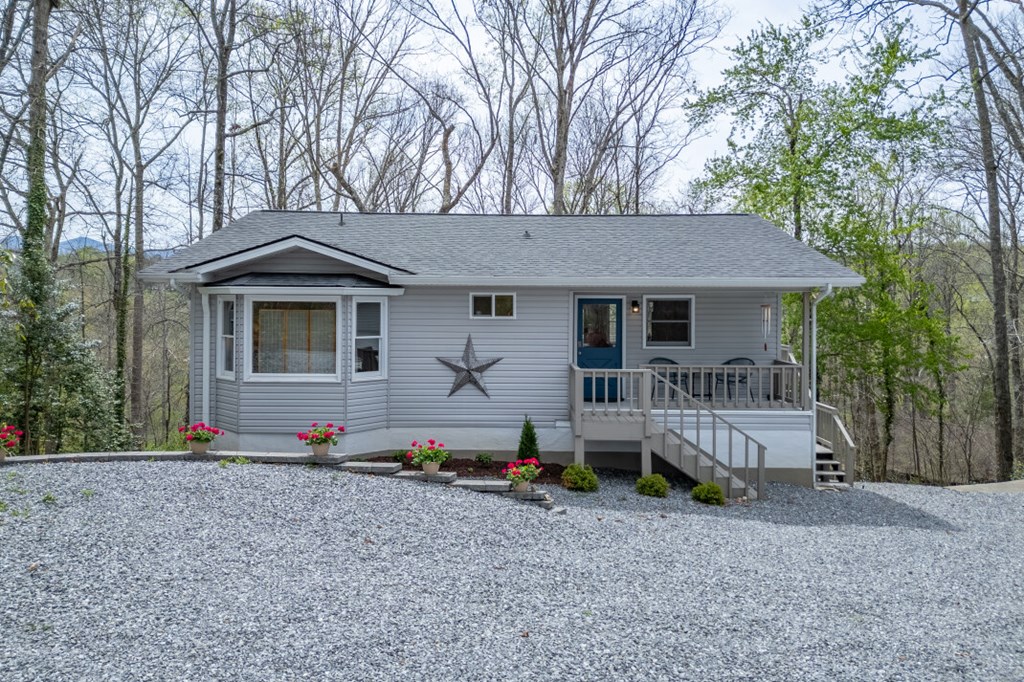 1682 Settlement Road Young Harris, GA 30582 - Photo 2 of 72 a front view of a house with a yard and garage