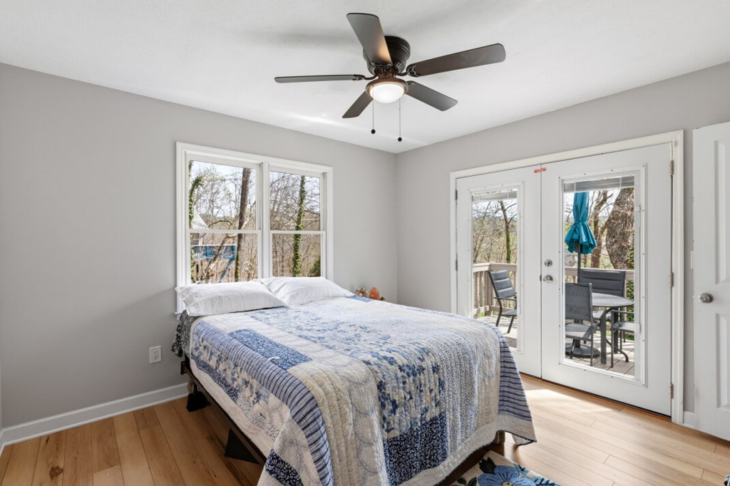 1682 Settlement Road Young Harris, GA 30582 - Photo 24 of 72 a bedroom with a large bed a chandelier and a window