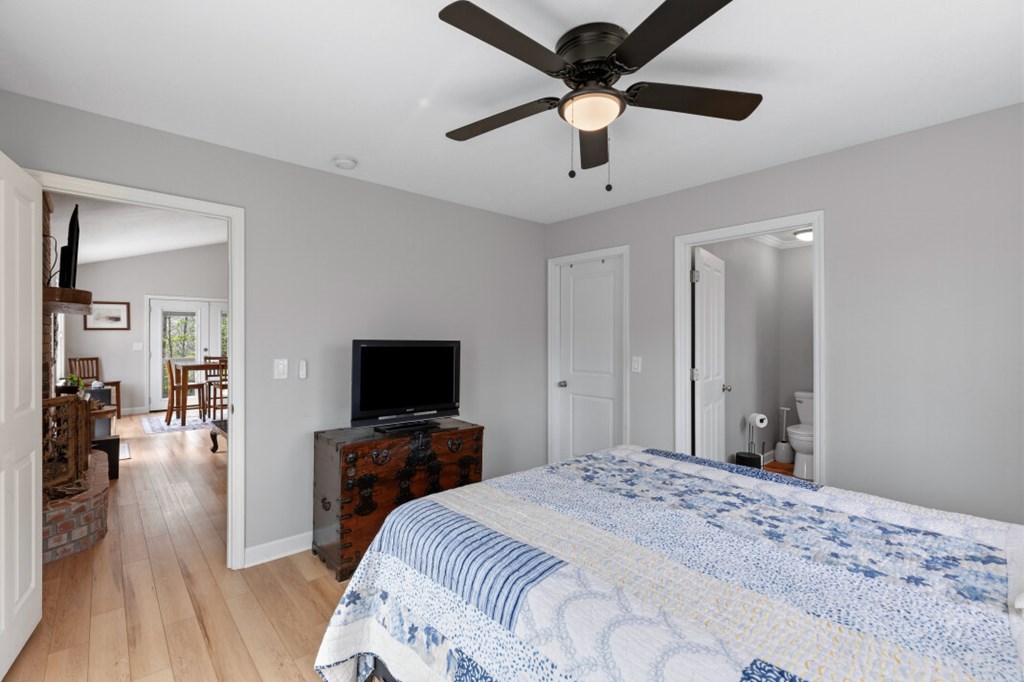1682 Settlement Road Young Harris, GA 30582 - Photo 25 of 72 a bedroom with a bed and a flat tv screen on dresser