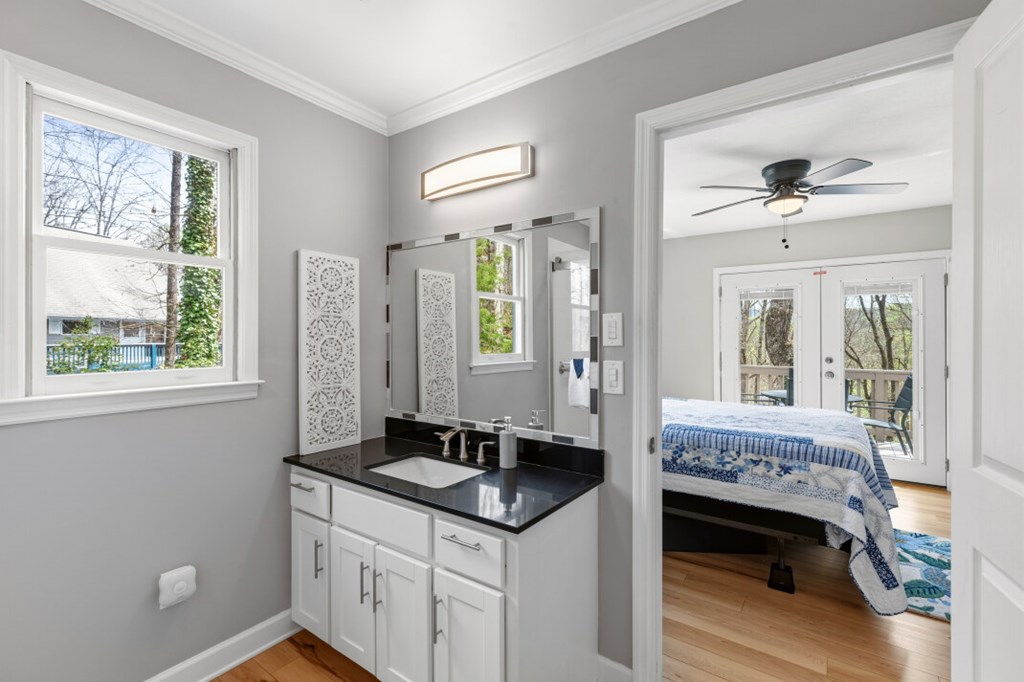 1682 Settlement Road Young Harris, GA 30582 - Photo 27 of 72 a en suite bathroom with a granite countertop sink and a mirror