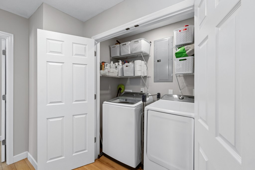 1682 Settlement Road Young Harris, GA 30582 - Photo 30 of 72 a view of washer and dryer with kitchen in the background