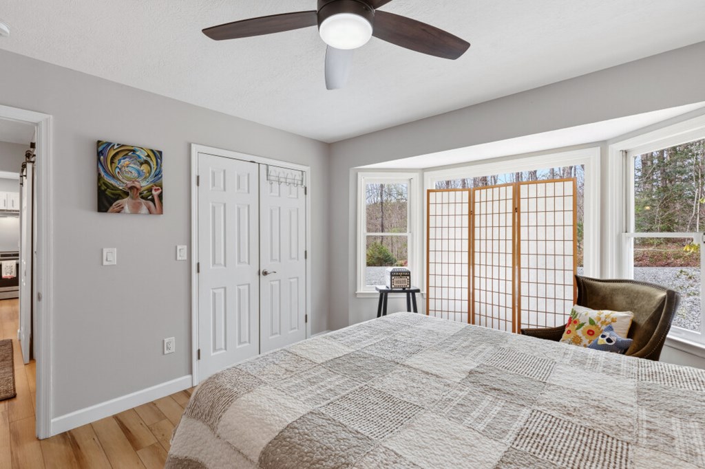 1682 Settlement Road Young Harris, GA 30582 - Photo 35 of 72 a spacious bedroom with a large bed and a window